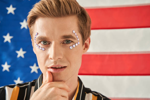 istock Man with rhinestones at his face looking thoughtful and confident at the camera 1349675310