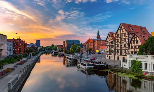 Panorama of Old town with reflection in Brda River at sunrise, Bydgoszcz, Poland