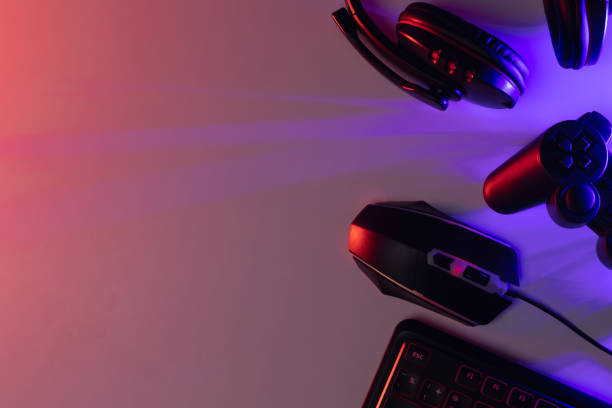 istock Accessory gaming keyboard joystick mouse headphone with blank space. Gadget for gamer playing video game online in the neon light darkroom. 1349678573