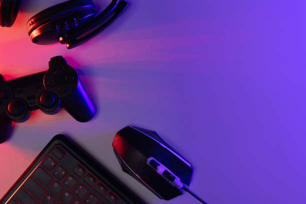 istock Accessory gaming keyboard joystick mouse headphone with blank space. Gadget for gamer playing video game online in the neon light darkroom. 1349678585