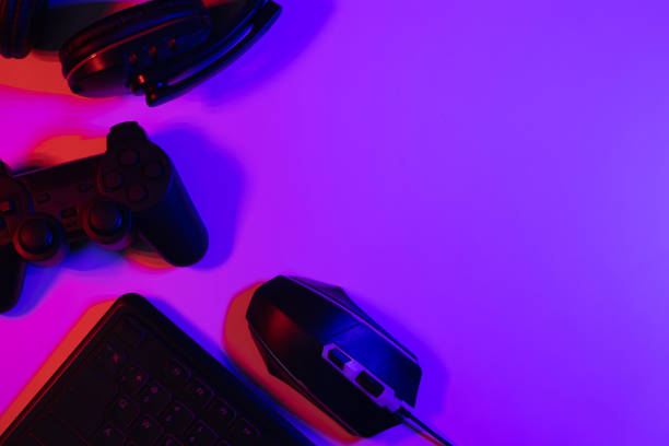 istock Accessory gaming keyboard joystick mouse headphone with blank space. Gadget for gamer playing video game online in the neon light darkroom. 1349678588