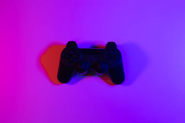 istock Accessory gaming joystick with blank space. Gadget for gamer playing video game online in the neon light darkroom. 1349678595
