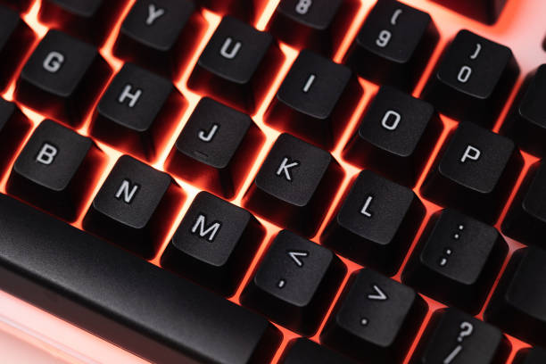 istock Colorful Accessory gaming keyboard with blank space background. Gadget for gamer playing video game online in the neon light darkroom. 1349678623