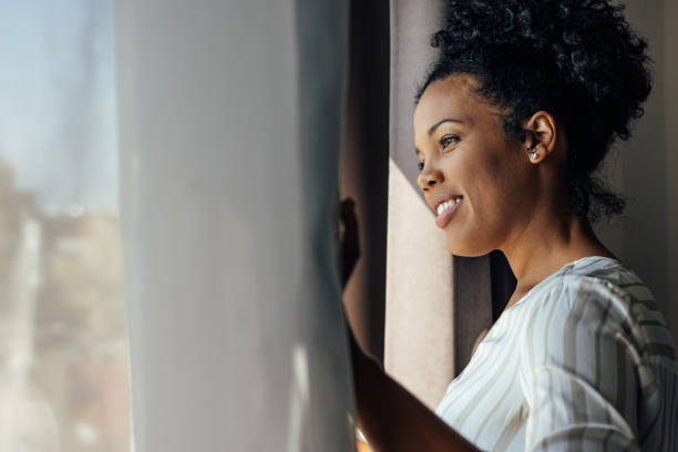 istock African-american woman, checking if it rains 1349678747