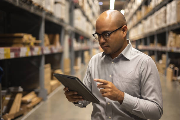 istock Young manager worker checklist manage parcel box product in warehouse. Asian supervisor man using tablet working at store industry. Logistic import export concept. 1349679414