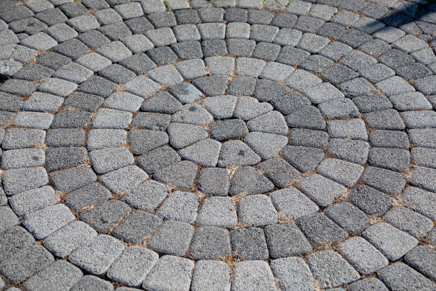 istock Round stone pavement pattern. Sidewalk tiles laid out from the center. 1349681326