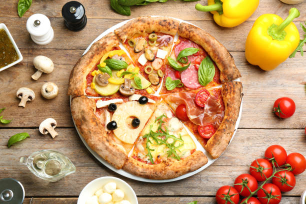 istock Slices of different pizzas on wooden table, flat lay 1349681585