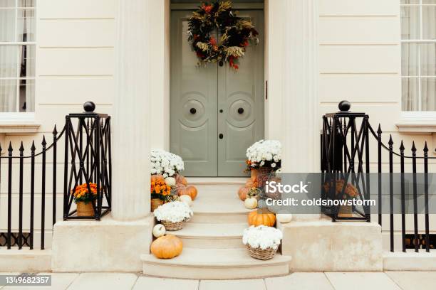 Pumpkins On Front Steps Of Houses Decorated For Halloween Stock Photo - Download Image Now