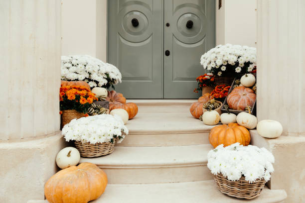 istock Pumpkins on front steps of houses decorated for Halloween 1349682379
