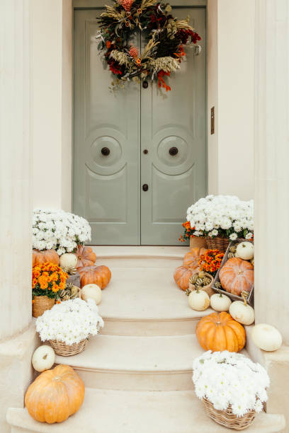 istock Pumpkins on front steps of houses decorated for Halloween 1349682423
