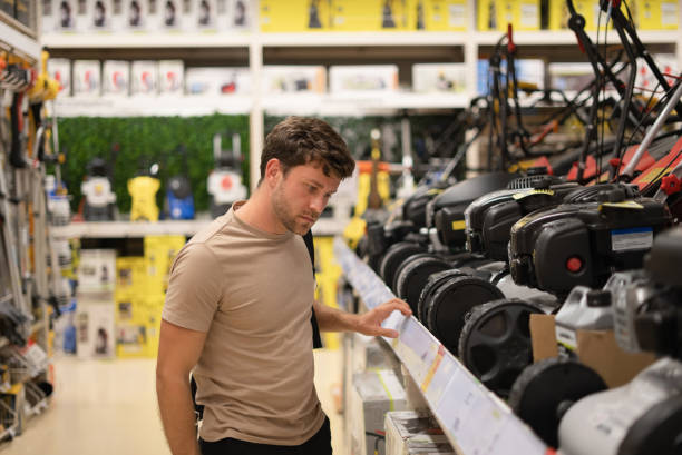 istock Man in shop with lawn mowers 1349683933