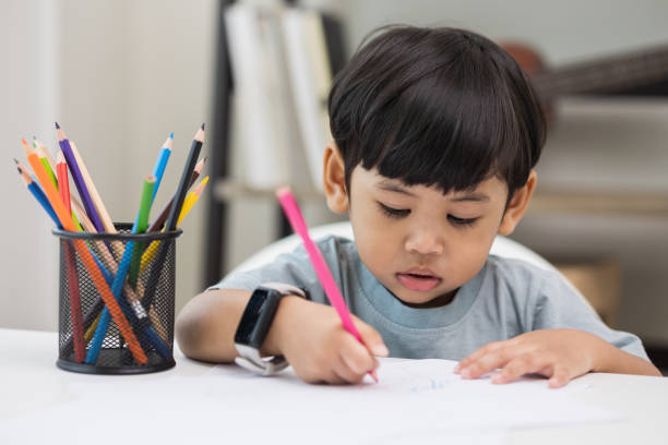 istock Asian little boy education from home. Developing children's learning before entering kindergarten Practice the skills of drawing and painting. 1349688631