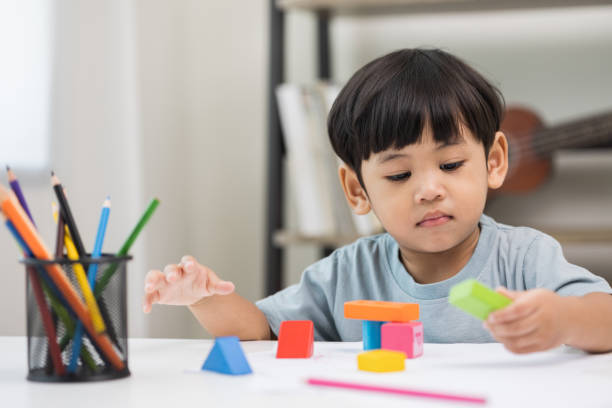 istock Asian little boy education from home. Developing children's learning before entering kindergarten Practice the skills of playing with wooden toys in living room. 1349688641