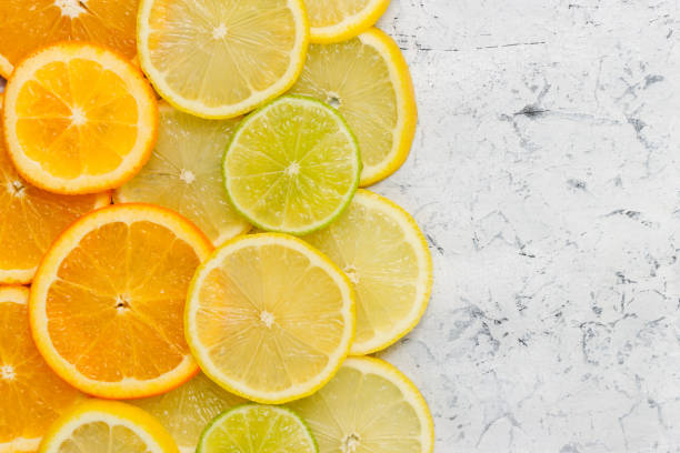 istock Sliced citrus fruits on concrete background with copy space 1349689614
