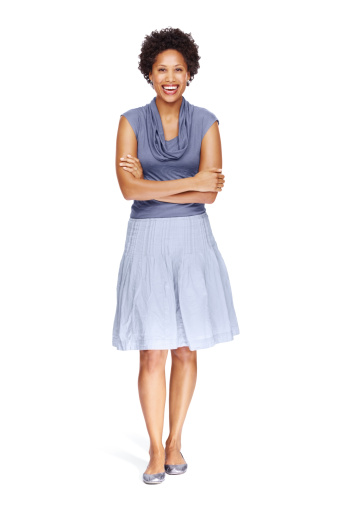Full-length portrait of a relaxed young woman standing on white background
