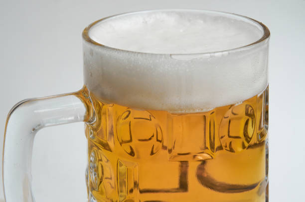 istock Mug of beer with foam on white background 1349696403