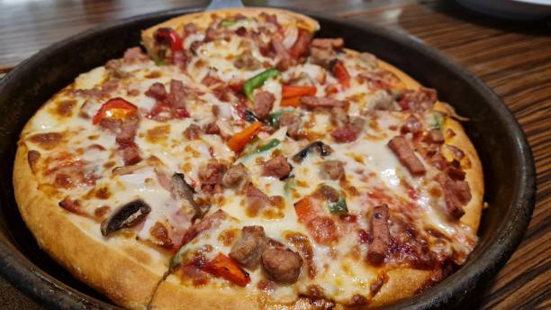 istock pizza topped with various vegetables, beef and mozzarella cheese 1349696734