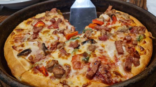 istock pizza topped with various vegetables, beef and mozzarella cheese 1349696771