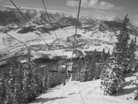 Looking down from the chair lift to the ski resort of Crested Butte on a sunny day.  (bw)