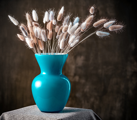 Fluffy flower in a vase on a table background, Floral Still Life Concept
