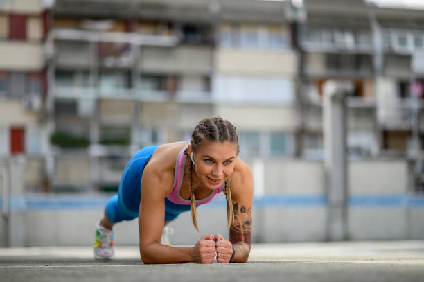 istock Attractive young woman in a plank position while training outside 1349700275