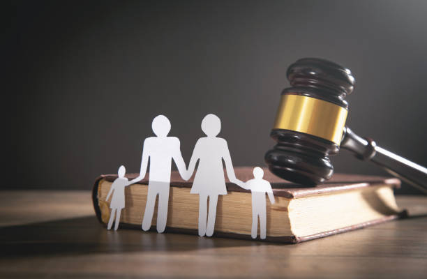 Paper cut family, judge gavel and book. Family Law stock photo