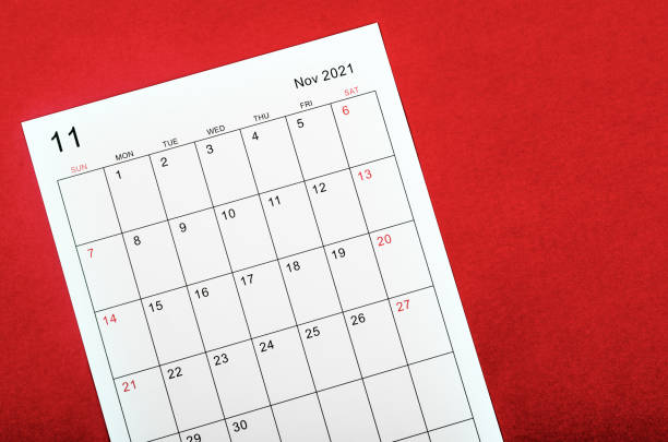 istock November 2021 calendar sheet on red background. 1349701052