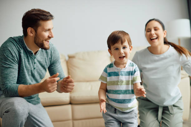 istock Little boy having fun while playing with his parents at home. 1349701187