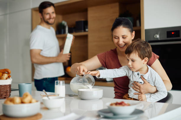 istock Happy mother and son enjoying in breakfast at home. 1349701414