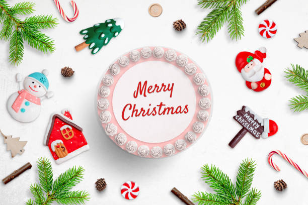 istock Making a Christmas cake concept. A cake with Merry Christmas greeting text, surrounded by fondant figurines 1349706047