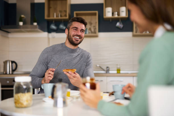 istock Young happy couple having breakfast at home 1349706447
