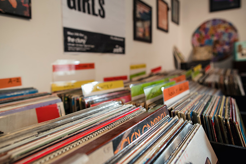 vinyl music records stack on the shelf with headphones on top