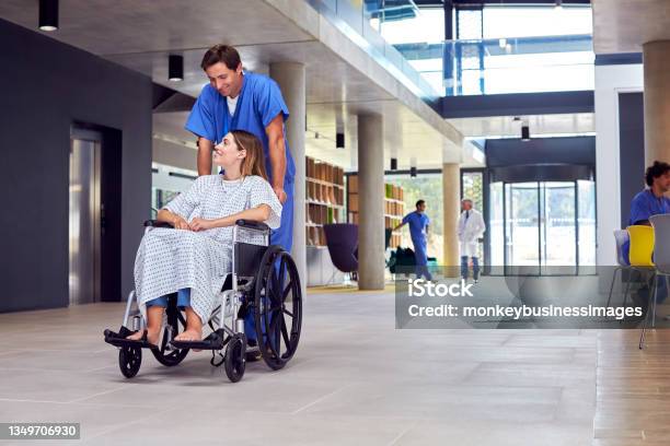 Multicultural Medical Team Wearing White Coats And Scrubs Discuss Patient Scan Meeting In Hospital Stock Photo - Download Image Now