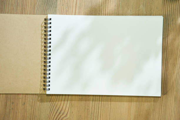 istock blank sketch book on wood table top 1349709138