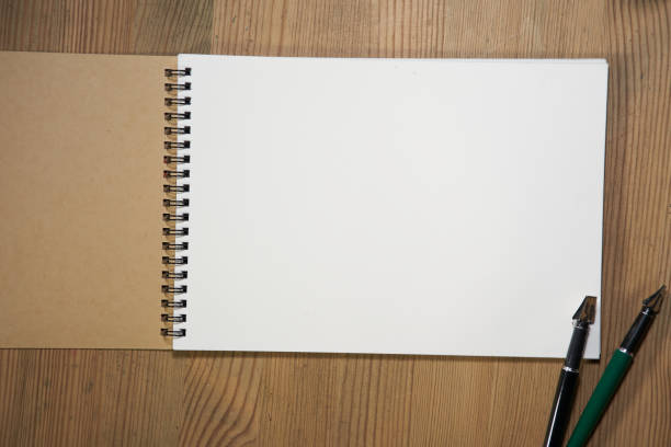 istock blank sketch book on wood table top 1349709143