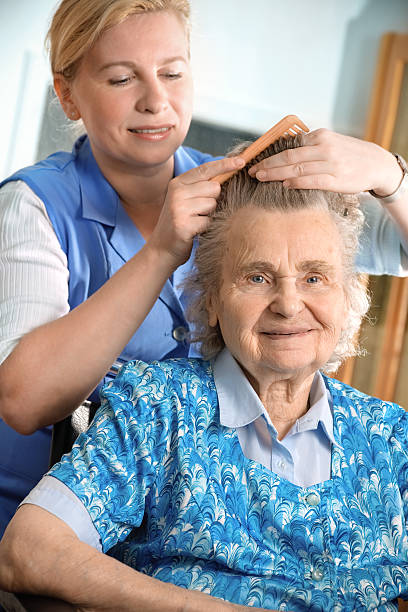 istock Woman in nursing home brushing hair 134971049