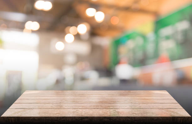 istock Empty wooden table top with lights bokeh on blur restaurant background 1349714925