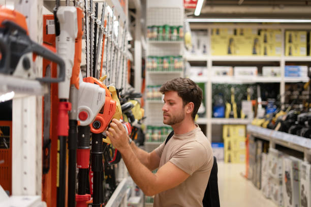 istock Male choosing trimmer from gardening tools 1349716466