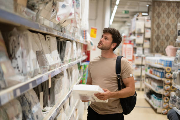 istock Man choosing new linen in home store 1349717103