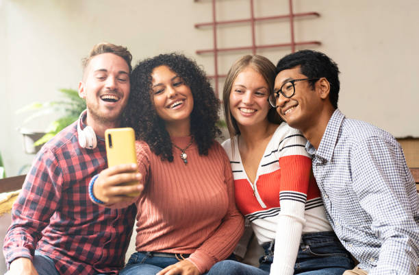 istock Young friends group making selfie with smartphone - Community concept with multicultural and multiethnic friends having fun video calling with friends - Diversity and friendship concept 1349717207