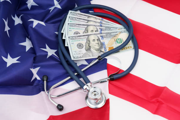 istock Stethoscope and dollars on the USA flag. 1349717442