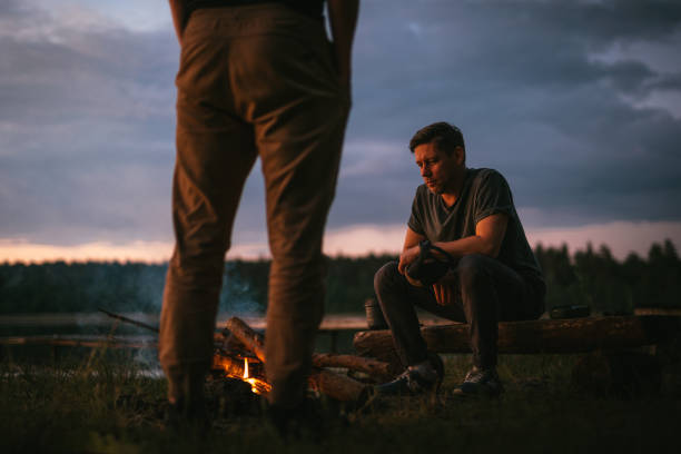 istock Friends burning bonfire on a lakeshore. Summer sunset 1349727501
