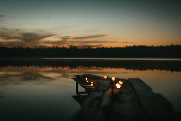 istock Illuminated wooden pier on a lake. Idyllic landscape 1349728656