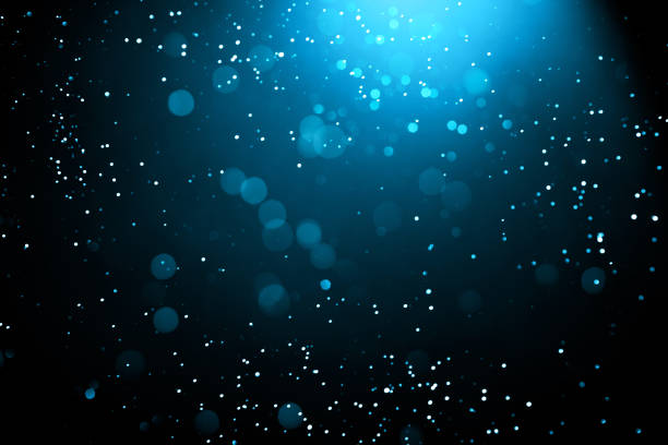 istock Abstract background with glowing turquoise particles. 1349755394