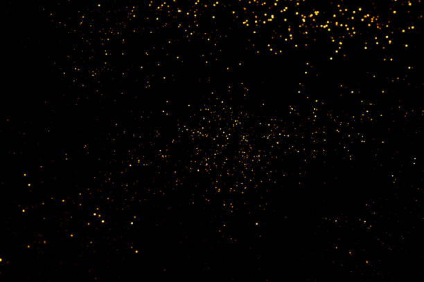 istock Golden abstract bokeh on black background. 1349756263