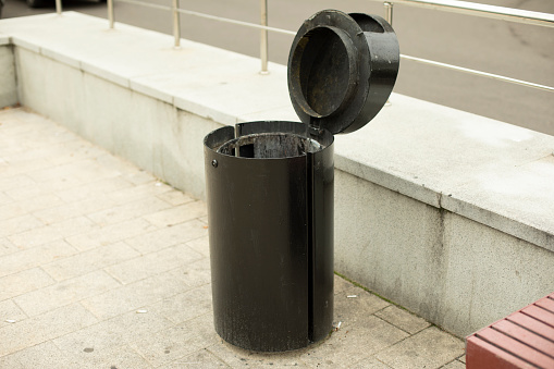 Black urn. The city's garbage dump for small garbage. The place of waste disposal in the city.
