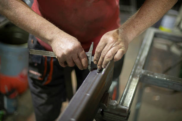 istock The worker works with metal. Construction tools, hands close-up. Work in the factory. 1349761737
