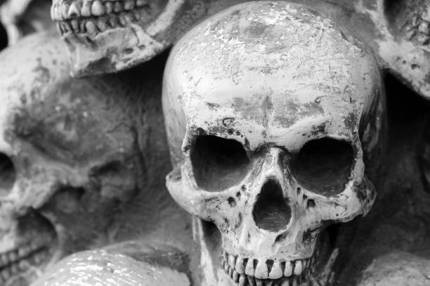 istock Artificial human skull close-up as background for congratulations to Halloween 1349761835