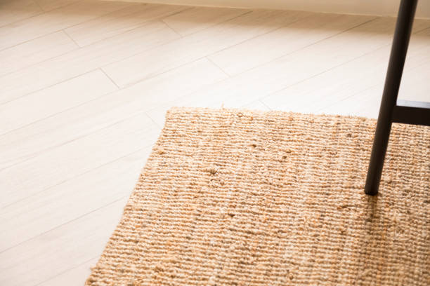 istock Stylish wicker rug on floor in living room. 1349761870