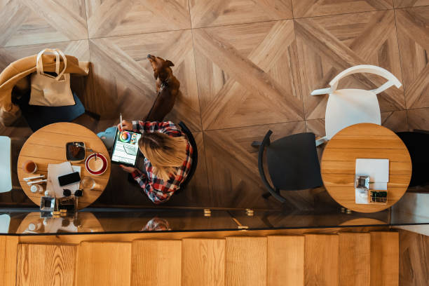 istock At modern coffee shop, modern young woman working remotely on her tablet 1349767458
